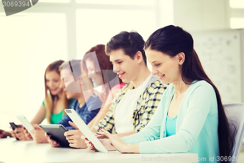 Image of smiling students with tablet pc at school