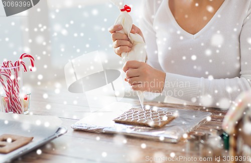 Image of close up of woman making gingerbread houses