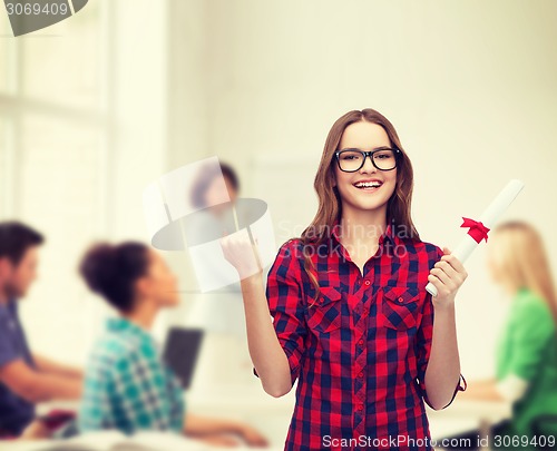 Image of smiling female student in eyeglasses with diploma