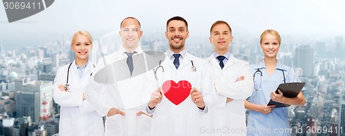 Image of group of smiling doctors with red heart shape