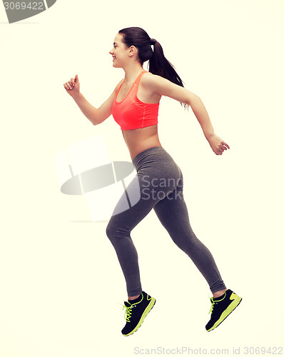 Image of sporty woman running or jumping