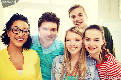 Image of group of smiling people at school or home