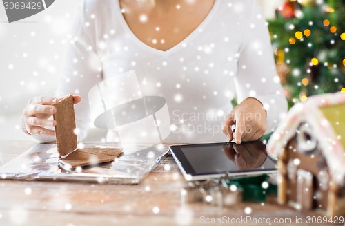 Image of close up of woman making gingerbread houses