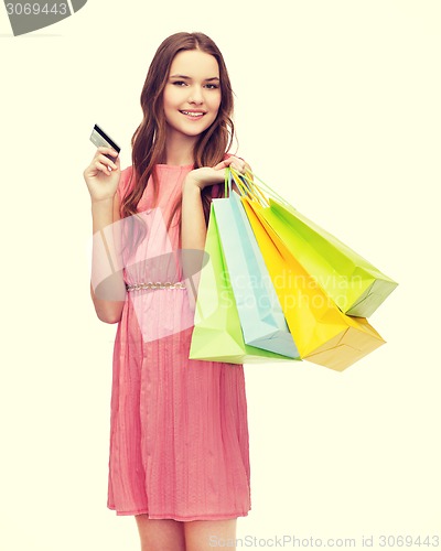 Image of smiling woman in dress with many shopping bags