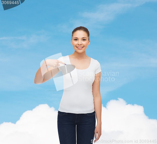 Image of smiling young woman in blank white t-shirt