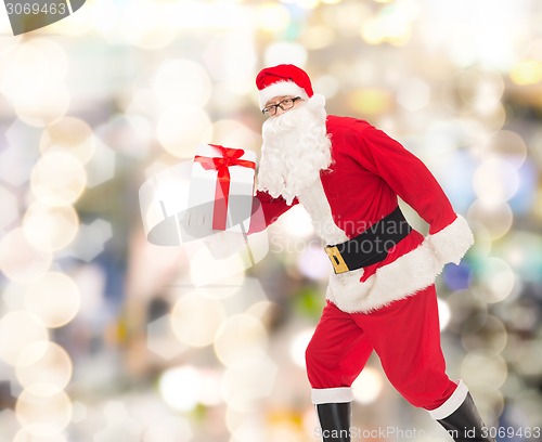 Image of man in costume of santa claus with gift box