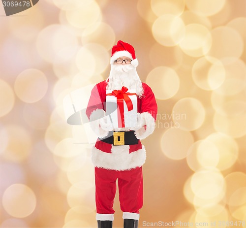 Image of man in costume of santa claus with gift box