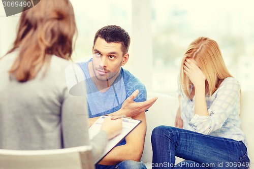 Image of young couple with a problem at psychologist office