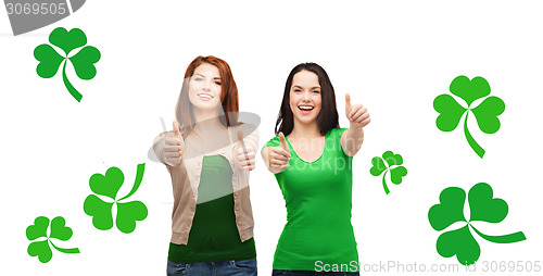 Image of two smiling girls showing thumbs up with shamrock