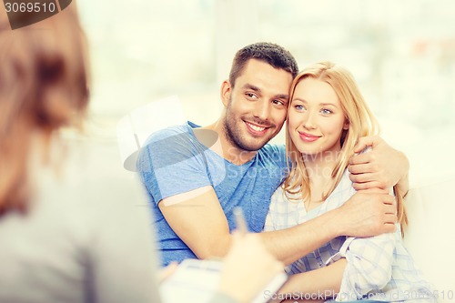 Image of young couple hugging at psychologist office