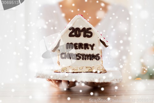 Image of close up of woman showing gingerbread house