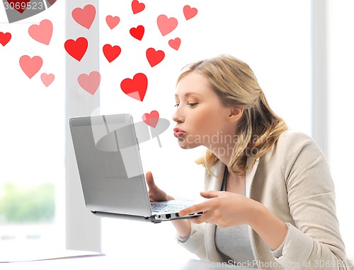 Image of woman sending kisses with laptop computer