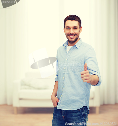 Image of smiling man showing thumbs up