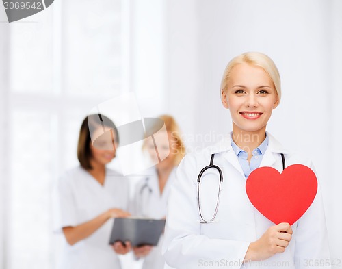 Image of smiling female doctor with heart and stethoscope