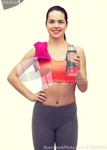 Image of sporty woman with towel and water bottle