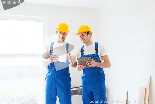 Image of builders with tablet pc and equipment indoors