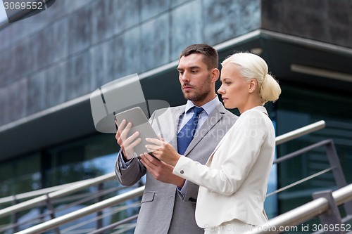 Image of businesspeople with tablet pc outdoors