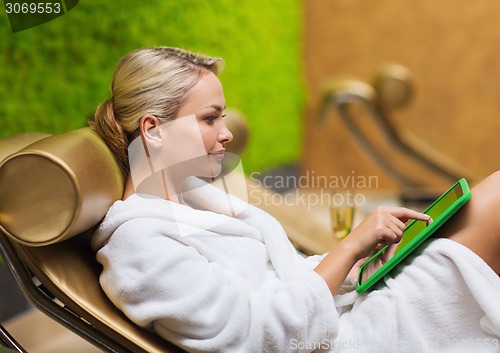 Image of beautiful young woman with smartphone at spa