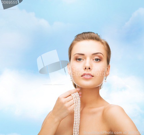 Image of beautiful woman with pearl earrings and bracelet