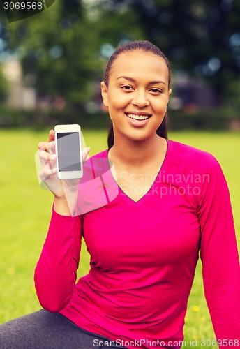 Image of smiling african american woman with smartphone