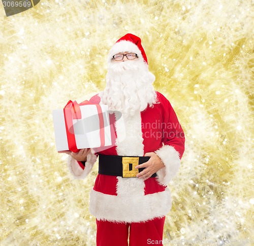 Image of man in costume of santa claus with gift box