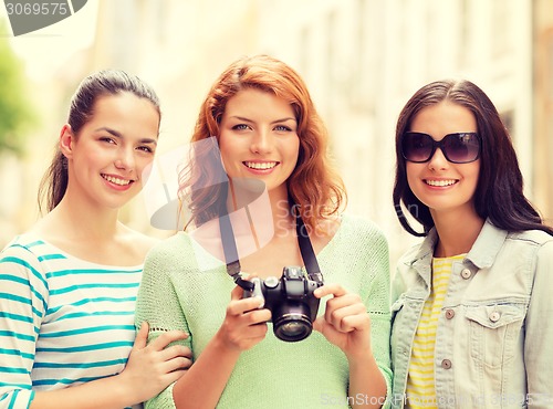 Image of smiling teenage girls with camera