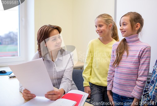 Image of group of school kids with teacher in classroom