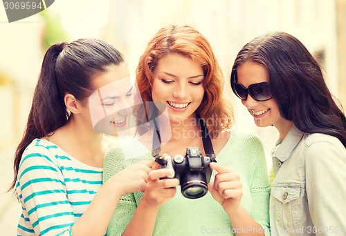 Image of smiling teenage girls with camera