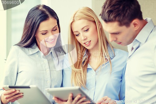 Image of business team working with tablet pcs in office