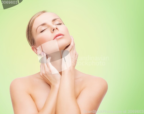 Image of beautiful young woman touching her neck