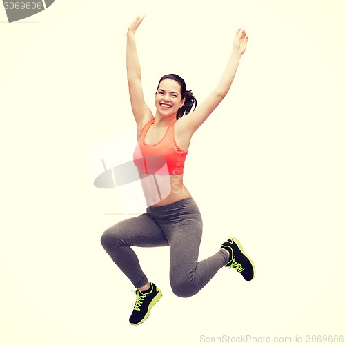 Image of sporty teenage girl jumping in sportswear