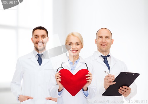 Image of group of smiling doctors with heart and clipboard