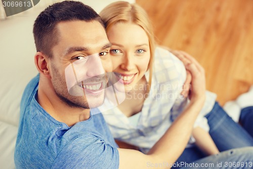 Image of smiling happy couple at home