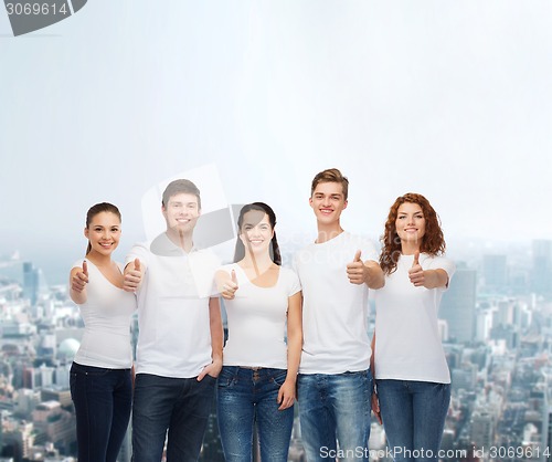 Image of smiling teenagers in t-shirts showing thumbs up