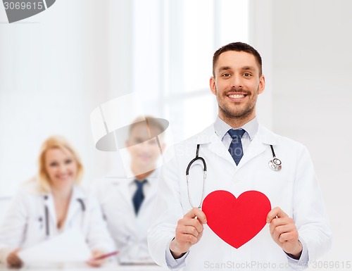 Image of smiling male doctor with red heart