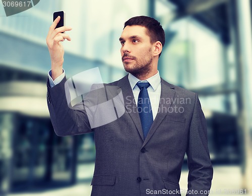 Image of young businessman with smartphone