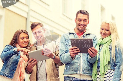 Image of group of smiling friends with tablet pc computers