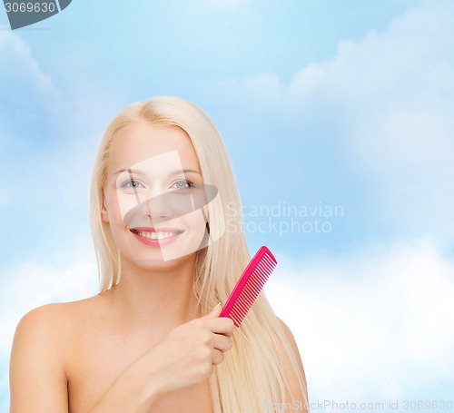 Image of smiling woman with hair brush