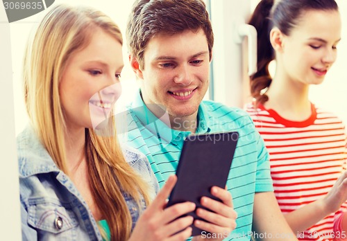 Image of smiling students with tablet pc at school