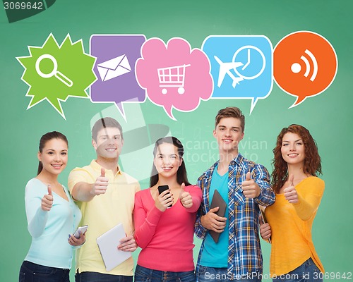 Image of group of teenagers with smartphones and tablet pc