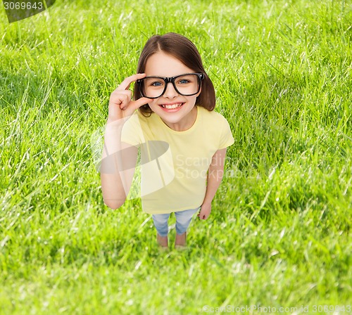 Image of smiling little girl in black eyeglasses