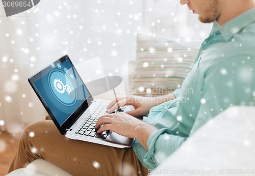 Image of close up of man working with laptop at home