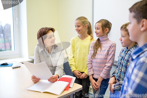 Image of group of school kids with teacher in classroom