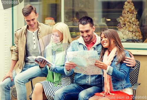 Image of group of friends with guide and map exploring town