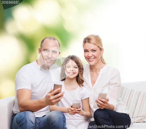 Image of happy family with smartphones