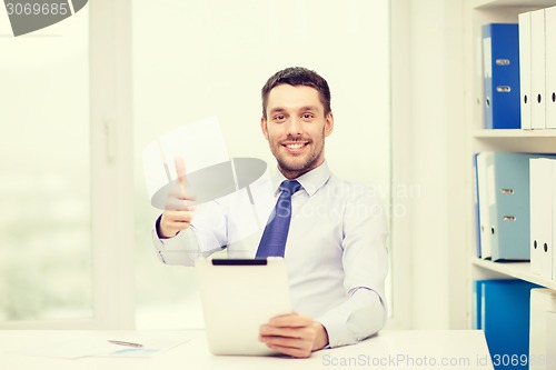 Image of smiling businessman with tablet pc and documents