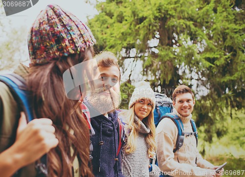 Image of group of friends with backpacks and tablet pc