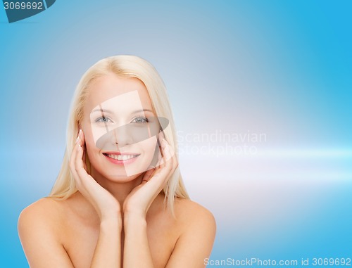 Image of beautiful woman touching her face skin