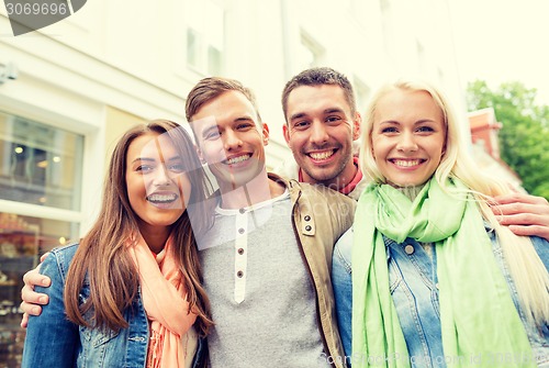 Image of group of smiling friends in city