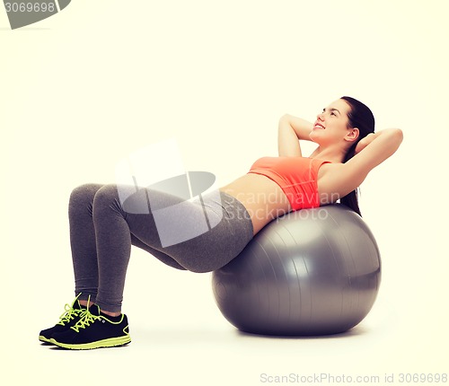 Image of teenage girl doing exercise on fitness ball